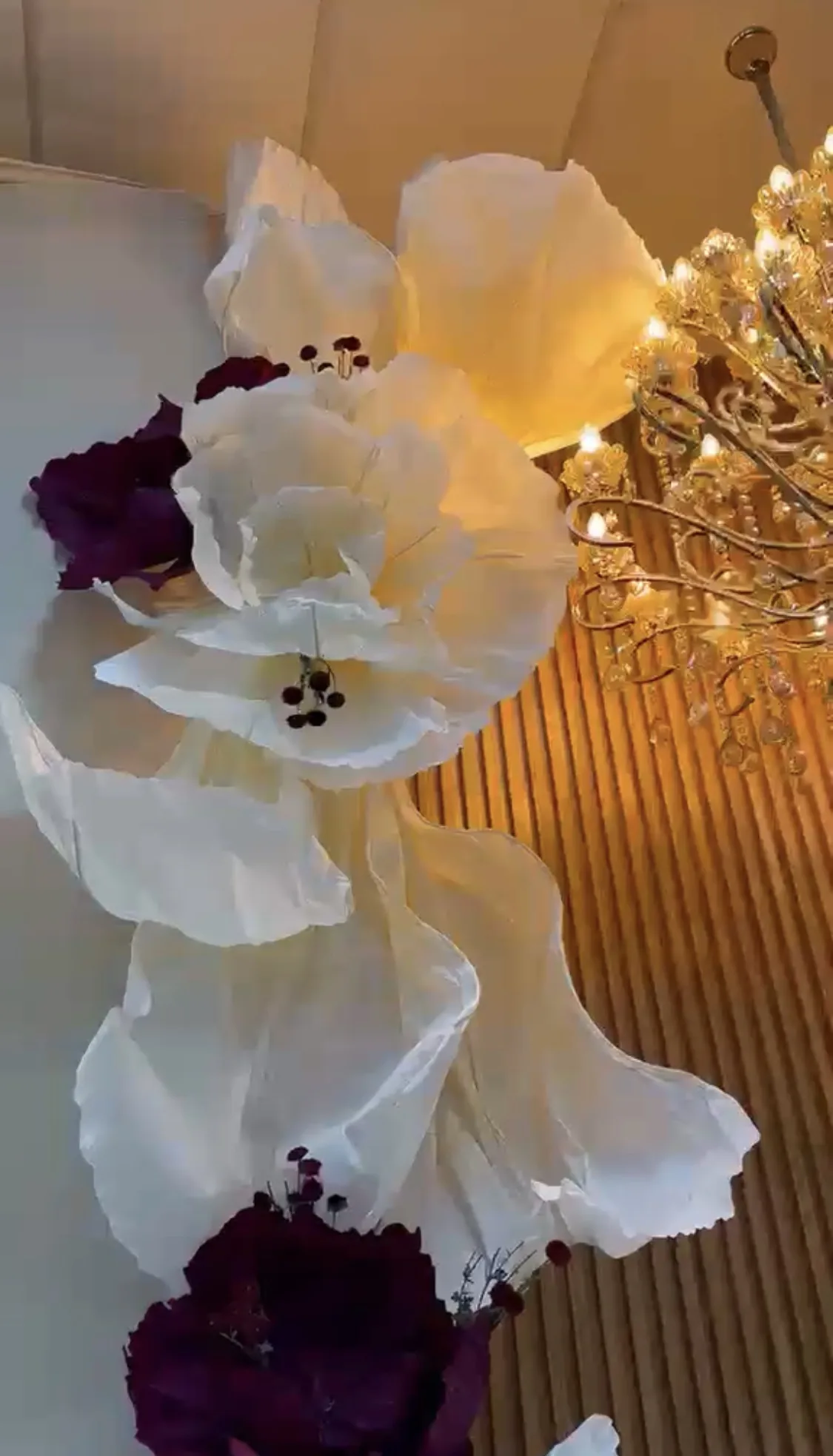 Arrangement of white and burgundy Oversized Flowers in a sophisticated setting
